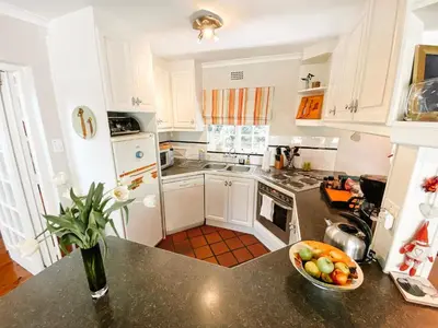 a kitchen with a bowl of fruit on a counter at Jonquil Guest Cottage in Franschhoek