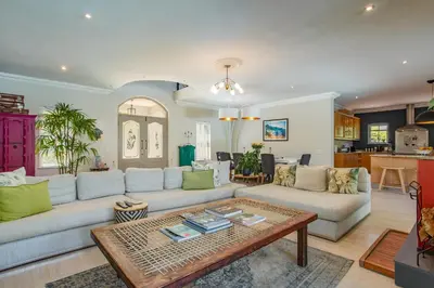 a living room with a couch and a table at Luxury Five Bed House in the Heart of Franschhoek in Franschhoek