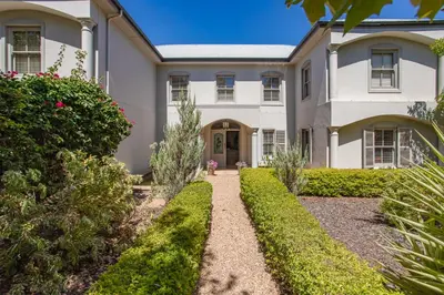 a large white house with a pathway at Luxury Five Bed House in the Heart of Franschhoek in Franschhoek