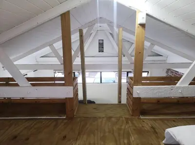 a room with two bunk beds in a attic at Coastal Cozy Home in Cape Town