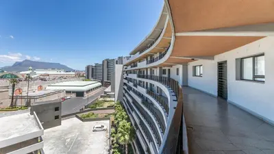 an apartment balcony with a view of a city at Waters Edge in Cape Town