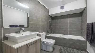 a bathroom with a sink and a toilet and a mirror at Waters Edge in Cape Town