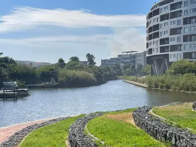 a river in a city with buildings in the background at Waters Edge in Cape Town