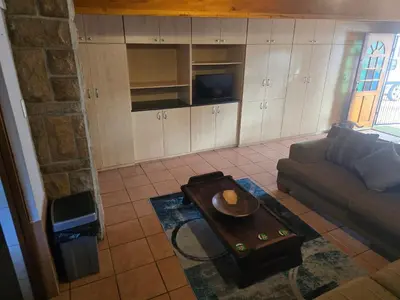 a living room with a couch and a table at Urban Retreat in Cape Town
