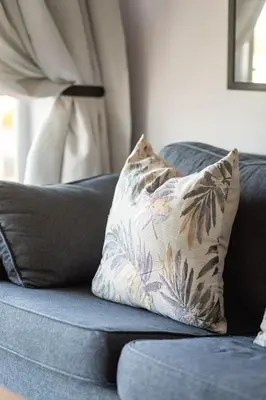 a blue couch with a pillow on top of it at Ocean Whisper Unit 79 in Hermanus