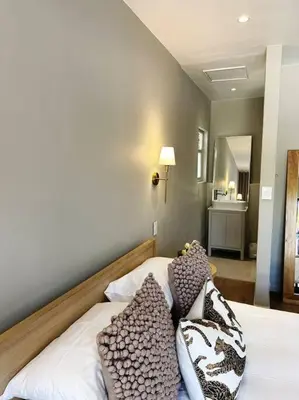 a bedroom with a bed with pillows on it at Stellenbosch Winelands Apartment in Stellenbosch