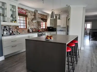 a kitchen with a island with a bowl of fruit on it at Champers with a view in Cape Town