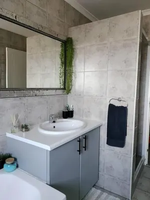 a bathroom with a white sink and a mirror at Champers with a view in Cape Town