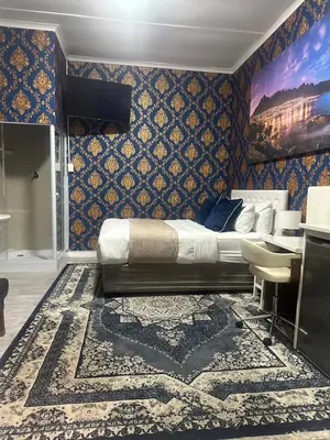 a bedroom with a bed and a blue wall at Prime Executive Accommodation in Cape Town