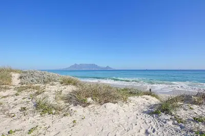 a sandy beach with the ocean in the background at Beachfront Luxury Living- A106 Seaspray, Blouberg in Bloubergstrand