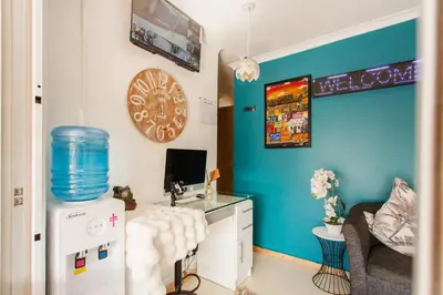 a room with a desk with a sink and a clock at Caline VIP Luxury Jacuzzi &, Swimming Pool MEWS in Cape Town