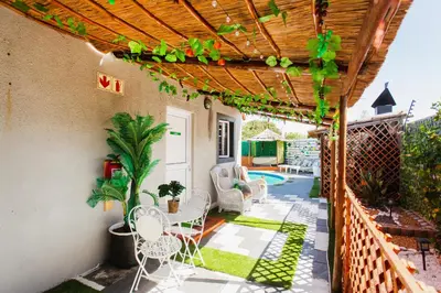 a patio with a table and chairs and a fence at Caline VIP Luxury Jacuzzi &, Swimming Pool MEWS in Cape Town