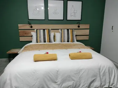 a bedroom with a white bed with two towels on it at Champers in Cape Town