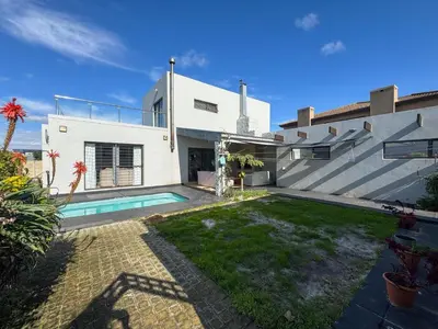 a house with a swimming pool in the yard at Spacious Double Room for Two with Pool, Braai, Gas Stove, Complete Kitchen, Fast WiFi and Private Bathroom in Cape Town
