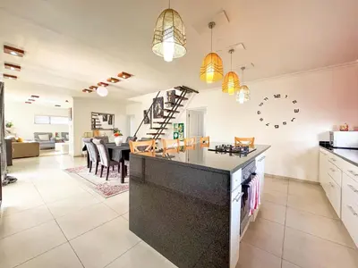 a kitchen and living room with a dining room at Spacious Double Room for Two with Pool, Braai, Gas Stove, Complete Kitchen, Fast WiFi and Private Bathroom in Cape Town