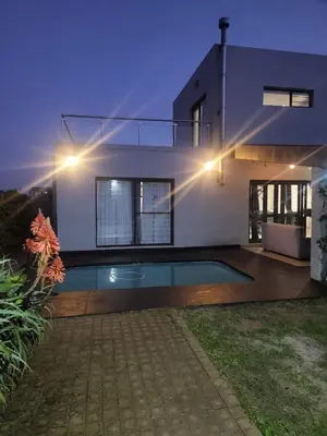 a house with a swimming pool in front of it at Spacious Double Room for Two with Pool, Braai, Gas Stove, Complete Kitchen, Fast WiFi and Private Bathroom in Cape Town