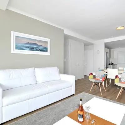 a white living room with a white couch at Private Blouberg Beachfront Getaway in Cape Town