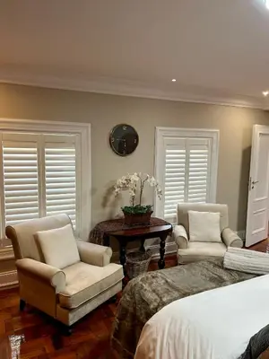 a bedroom with two chairs and a bed and a table at French Manor 2 Stellenbosch in Stellenbosch