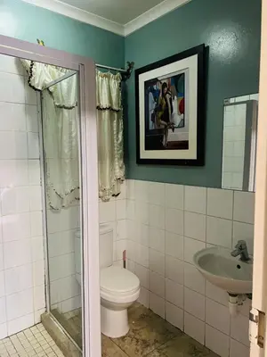 a bathroom with a toilet and a sink at Parow city -Star Legend Lodge in Cape Town