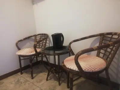 two chairs and a table with a speaker on it at Parow city -Star Legend Lodge in Cape Town