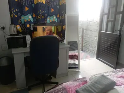 a bedroom with a desk and a chair and a mirror at The trout Lodge in Cape Town