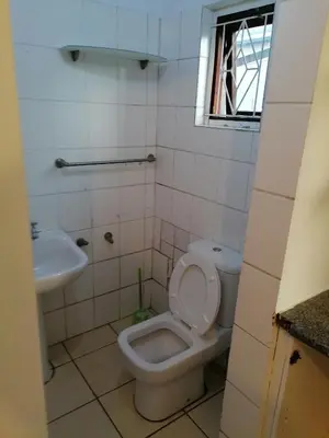 a bathroom with a toilet and a sink at 37 Grant prix lodge in Cape Town