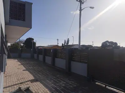 a fence in front of a building with a street light at 160 On Townsend Guesthouse in Cape Town