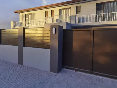 a house with a gate and a building at 160 On Townsend Guesthouse in Cape Town