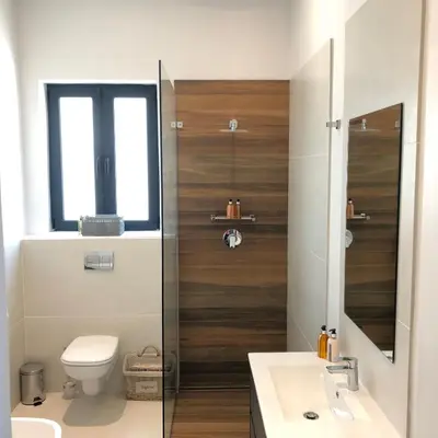 a bathroom with a toilet and a sink and a window at Bo La Motte Farm Cottages in Franschhoek