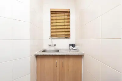 a bathroom with a sink and a window at Serena Inn Room 3 in Cape Town
