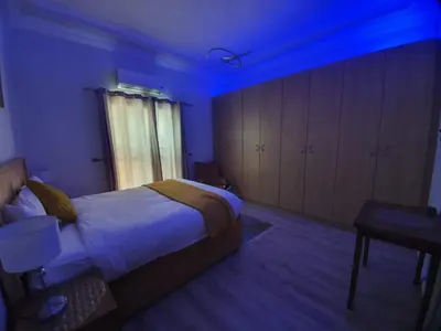a bedroom with a bed and a blue light at Serena Inn Apartment no5 Self Catering in Cape Town