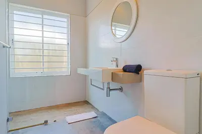 a bathroom with a sink and a mirror at Lily House in Bettyʼs Bay
