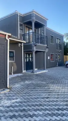 a large house with a driveway in front of it at Sabbath Lodge VIP in Cape Town