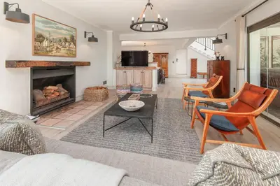 a living room with a couch and a fireplace at Casa La Vita in Hermanus