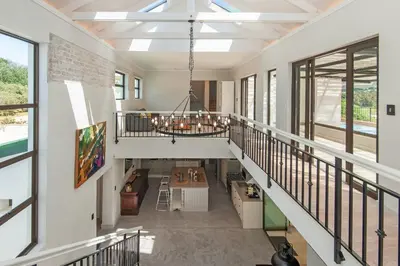 a room with a staircase with a chandelier at Casa La Vita in Hermanus