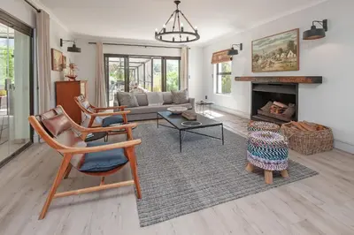 a living room with a couch and a fireplace at Casa La Vita in Hermanus