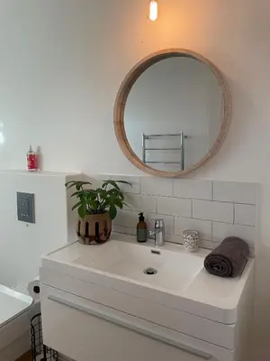 a bathroom with a white sink and a mirror at Sunset Beach Studio Apartment in Cape Town