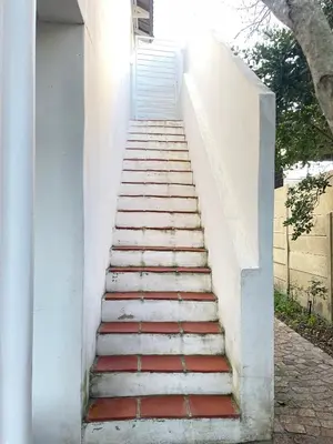 a set of stairs leading up to a house at Sunset Beach Studio Apartment in Cape Town