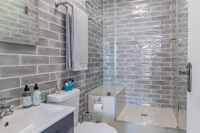 a bathroom with a toilet and a sink and a shower at Beach Front Sea View Apartment, Table View in Cape Town