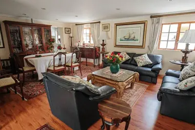 a living room with couches and a table in it at Rondebosch in Cape Town