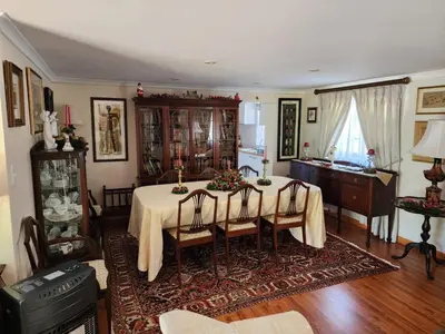 a dining room with a table and a kitchen at Rondebosch in Cape Town