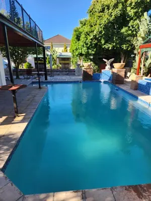 a large swimming pool with blue water at Rondebosch in Cape Town