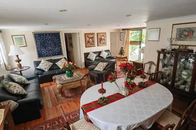 a living room with a table and a couch at Rondebosch in Cape Town