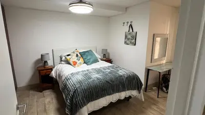 a bedroom with a bed with a gray blanket at Ocean View 1004 Luxury Backup Power in Strand