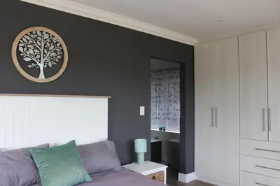 a living room with a couch and a tree picture on the wall at 17 Suikerbossie in Hermanus