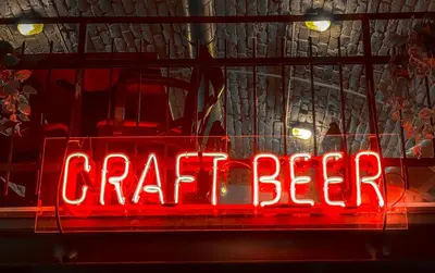 a red neon sign in the window of a store at Kape Loft in Cape Town