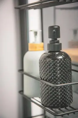 a bottle of soap sitting on a shelf in a closet at Kape Loft in Cape Town