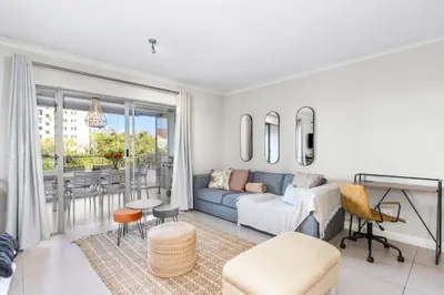 a living room with a couch and a table at Mayfair 246 by Host Agents in Cape Town