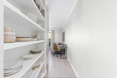 a white hallway with white shelving and plates at Mayfair 246 by Host Agents in Cape Town