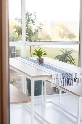 a table with a towel on it in front of a window at Coastal Living in Hermanus